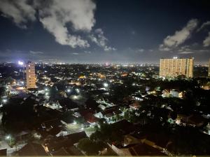 a view of a city at night with buildings at The si Ndoro Suite Amarta Patraland Yogyakarta in Yogyakarta
