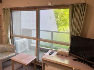 TV a/nebo společenská místnost v ubytování フューデイズコンドミニアム定山渓101号室