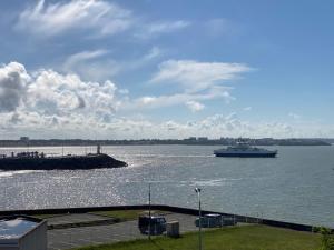 a large boat in the water near a dock at Villa face mer in Royan