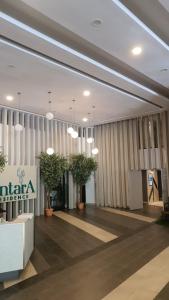 a lobby with potted plants in a building at Kami Tami Japandi Poolview in Putrajaya +15 photos