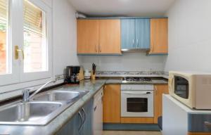 a kitchen with a sink and a microwave at Bravaholidays-602-Lloret Park 2 in Vidreres