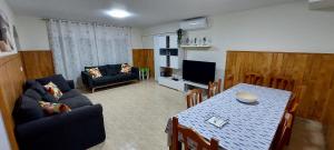 a living room with a table and a dining room at Bravaholidays-602-Lloret Park 2 in Vidreres