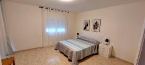 a small bedroom with a bed and a window at Bravaholidays-602-Lloret Park 2 in Vidreres +29 photos