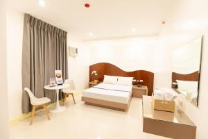 Postel nebo postele na pokoji v ubytování Hotel Dreamworld East Ortigas