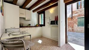 a kitchen with a table and chairs in a room at City Apartments Salute-Accademia in Venice
