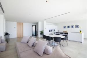 a white living room with a couch and a table at Villa Aqualeo in Adeje
