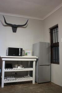 a kitchen with a refrigerator and a microwave at Helpmekaar in Wellington