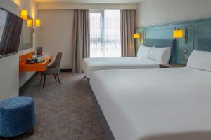 a hotel room with two beds and a desk at Crewe Hall Hotel & Spa - Cheshire in Crewe