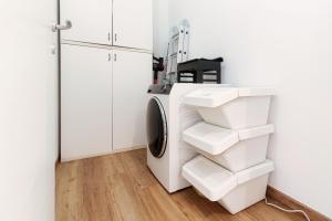 a white laundry room with a washer and dryer at Sandy - by MyHomeInComo in Cernobbio