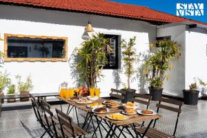 a wooden table with food on a patio at StayVista at The Alcove with Breakfast & BBQ Grill in Ooty