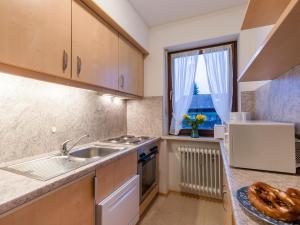 a kitchen with a sink and a window at Chiemgau Comfort D4 Ferienwohnanlage Oberaudorf mit Hallenbad und Sauna in Oberaudorf