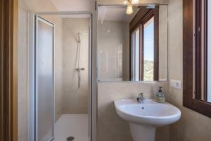 a bathroom with a shower and a sink and a shower at Plaza Iglesia in Frigiliana +17 photos