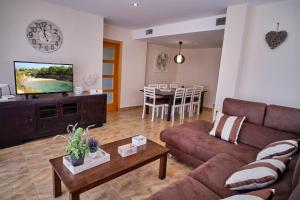 a living room with a couch and a table at Villa Almadrava in Tarragona