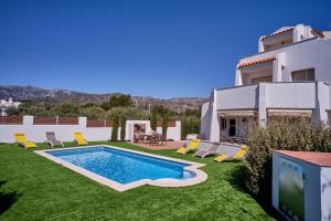 a house with a swimming pool in the yard at Villa Almadrava in Tarragona