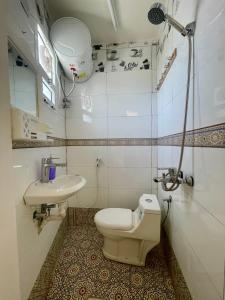 a bathroom with a toilet and a sink at Albustan House in Misfāh +37 photos