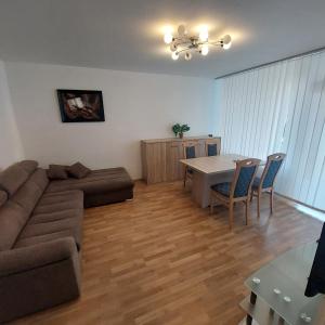 a living room with a couch and a table at 2 Zimmer Apartment Hannover in Hannover +6 photos