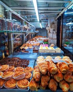 a bakery filled with lots of different types of pastries at Amar Priya guest house in Kolkata