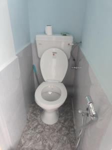 a bathroom with a white toilet in a stall at Keeon Private Room Top in Shillong