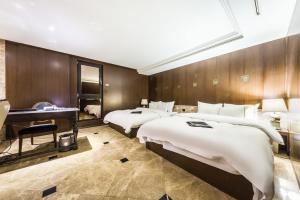 Letto o letti in una camera di Hotel Cullinan Wangsimni