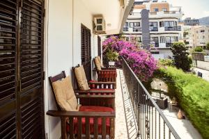 a balcony with chairs and flowers on a building at ENTER hostel in Kyrenia