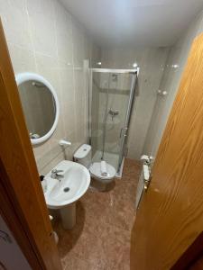 a bathroom with a shower and a sink and a toilet at Hostal La Rurala Estopanyà in Estopiñán +2 photos
