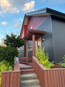 a red house with a wooden fence around it at Populasunupuri - Vacation STAY 62945v in Otaru