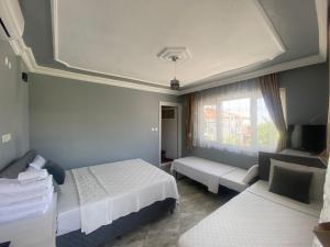 a hotel room with two beds and a window at Aspawa Hotel in Pamukkale