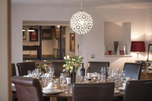 a dining room with a table with glasses and a chandelier at Hill Top Farm 22 in Bainbridge
