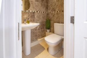 a bathroom with a toilet and a sink at Hill Top Farm 22 in Bainbridge +70 photos