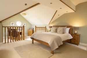 a bedroom with a large bed and a table at Hill Top Farm 22 in Bainbridge