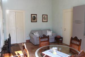 a living room with a table and a couch at Palazzo Trevisani in Porto San Giorgio