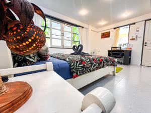 a bedroom with a bed and a desk in a room at Amy Village Apartments & Digital Hub in Lamai