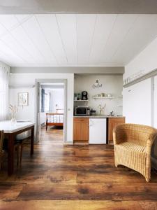 a kitchen with a table and a dining room at Pension Sandbogaard in Sandvig