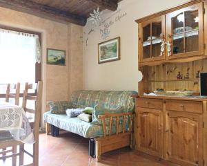 a living room with a couch and a cabinet at Soggiorno Vacanze Stella Alpina in Temù