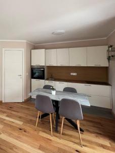 a kitchen with a table and chairs in a room at Casa Salvia in Koper