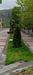 a park with benches on the side of a street at Kirch Hotel & Restaurant in Goris
