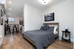 a bedroom with a bed and a table in a room at Capital Apartments in Ottawa