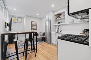 a kitchen with white cabinets and a counter top at Capital Apartments in Ottawa