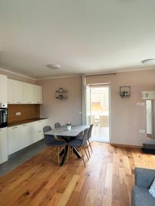 a kitchen and living room with a table and chairs at Casa Salvia in Koper +10 photos