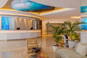 a lobby with a swimming pool on the ceiling at Pestana Blue Alvor Beach - All Inclusive Hotel in Alvor