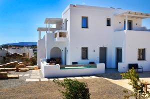 a white house with a pool in front of it at Lilian Studios in Koufonisia