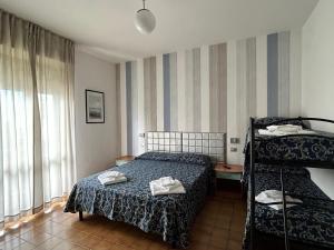 Postel nebo postele na pokoji v ubytování Hotel Etna - Hotel per Coppie e Famiglie con Parcheggio e Spiaggia + 55 fotografií