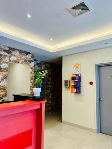 a lobby with a red counter and a gas station at Swing & Pillows -MyHome Hotel Wangsa Maju in Kuala Lumpur