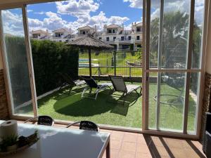 a view of a patio with chairs and an umbrella at Casa Leonardo Luxury Esury in Ayamonte