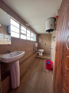 a bathroom with a sink and a toilet at HOTEL COUNTRY INN in Dimāpur