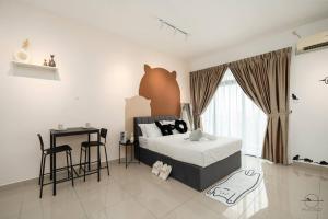 a bedroom with a bed and a table and a desk at [Cats Design Studio] #Level 27 #Austin #New condo in Johor Bahru +28 photos
