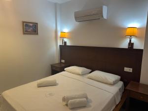 a bedroom with a bed with two towels on it at NATURELLA APART HOTEL in Kemer