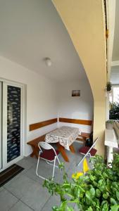 a patio with a table and chairs in a room at Apartment Tanya in Petrovac na Moru