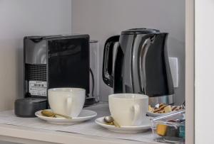 a counter with two cups and a coffee maker at Antique Spalato Luxury Rooms in Split