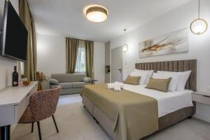 a hotel room with a large bed and a desk at Antique Spalato Luxury Rooms in Split
